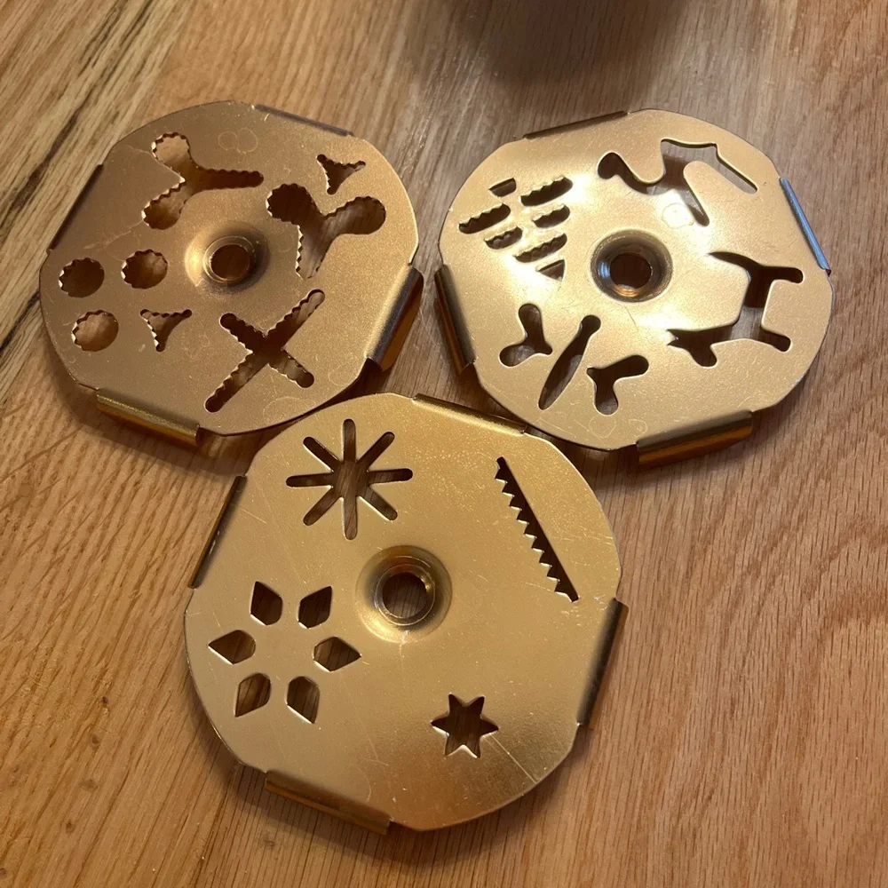 Cookie Press - aluminum and copper-tone with 3 discs that each have 4 designs